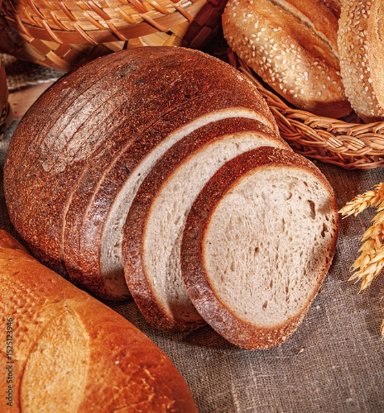 Obraz Fresh baked bread. Assorted bakery products loafs of bread and rolls...