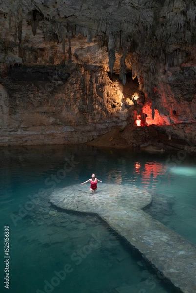 Obraz Woman standing on ancient mayan platform enjoying turquoise waters of cenote suytun, a magical place in yucatan, mexico