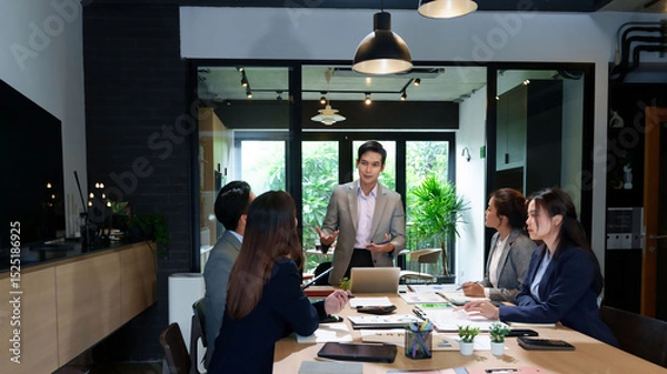 Obraz Business Meeting Presentation Asian Businessman Leading Discussion with Team in Modern Office Collaboration and Strategy in Conference Room