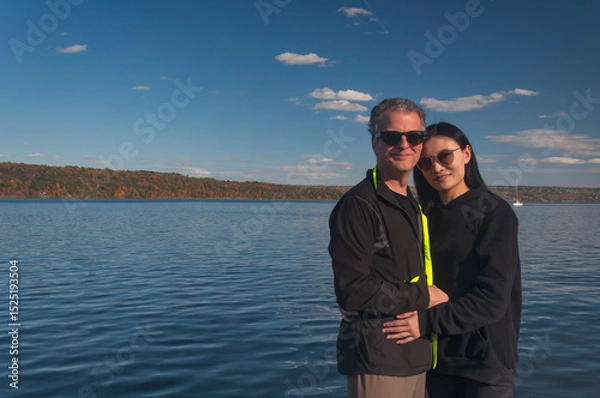 Obraz a happy couple in front of Cayuga lake new york in autumn