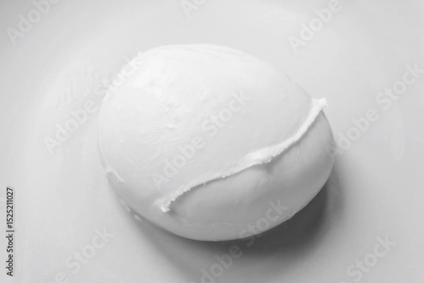 Fototapeta Buffalo mozzarella from Campania photographed on a neutral background. The fresh and artisanal texture. Realistic and minimalist image, with a high gastronomic and visual value.