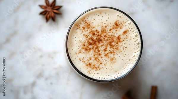 Fototapeta Aromatic chai latte with cinnamon and star anise on a marble surface presentation