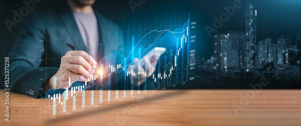 Fototapeta Financial technology and success: Hand holding a pen over a holographic display of increasing statistics, depicting innovation in finance and future market potential.