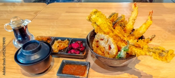 Fototapeta Tempura, deep fried in Japanese style, fish, shrimp and vegetables in rice bowl with soup and prickles in set menu in Japanese restaurant