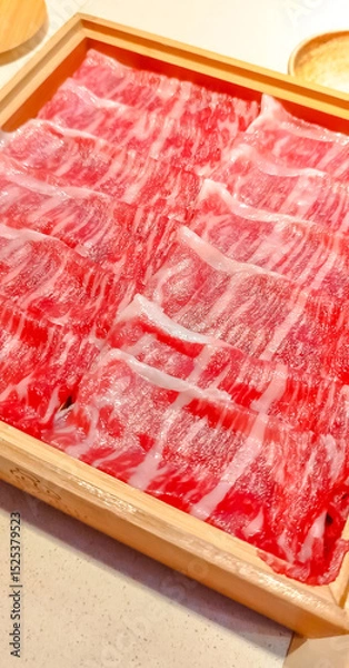 Fototapeta Japanese beef, wagyu, in thin sliced serves for shabu shabu, Japanese style hot pot, in luxury premium expensive restaurant