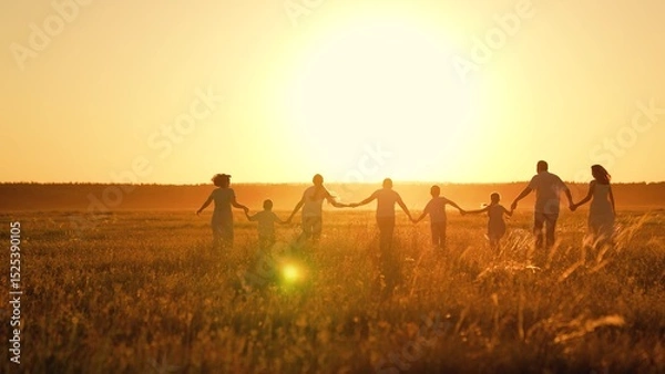 Obraz Parents children running walking in sunny park. Large group of people adults children enjoying nature. Family walk on grass of summer meadow. Happy family, children run on summer field holding hands