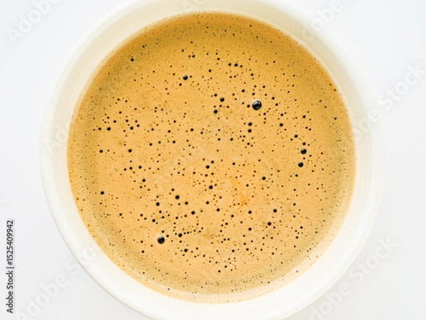 Obraz Cappuccino creamy milk foam texture in a white cup. Top view on white background. Design element.