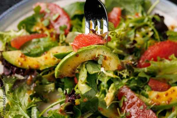 Fototapeta Fresh salad with grapefruit, avocado and pomegranate seeds