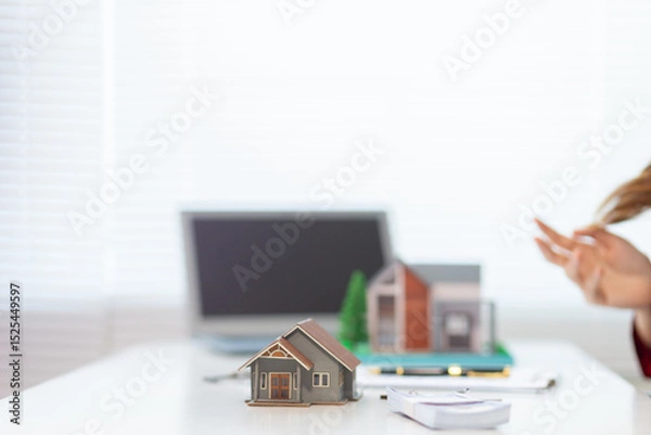 Obraz Mock up of a house model is placed on a table in a real estate office for real estate agents to use to mock up a model house for customers to decide on the house model they want. Copy Space for text