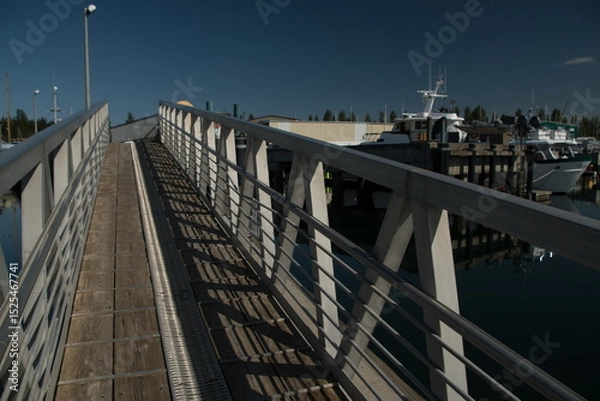 Obraz Walking through shadows at gangway in Boat Haven