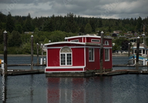 Obraz Red boathouse and its reflection in quiet waters of marina