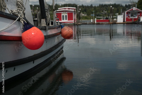 Obraz Red round boat fenders hanging of boat docked in Poulsbo marina