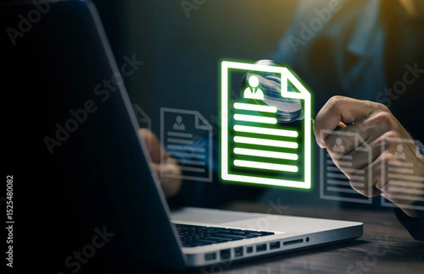 Fototapeta Businessman analyzing digital resume files on a laptop screen, symbolizing online recruitment, HR management, and digital document processing.