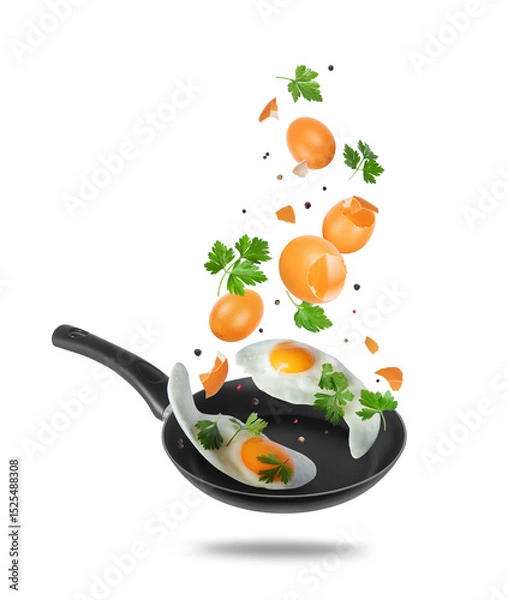Fototapeta Flying eggs, parsley and spices above a frying pan on light background