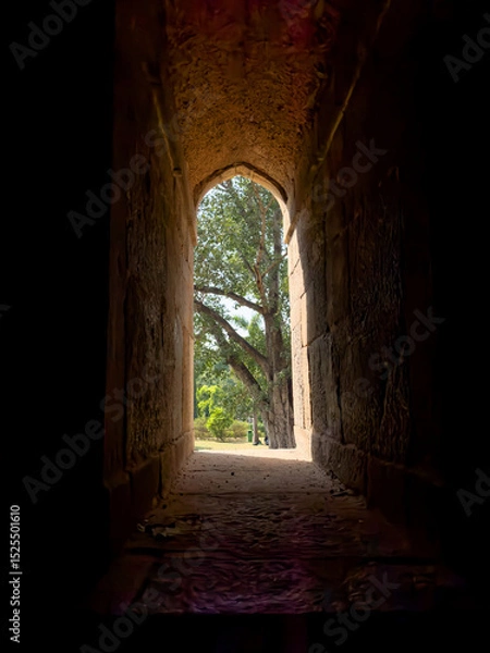 Obraz Window arch with stone frame, creating a narrow passage between light and shadow. Historic,