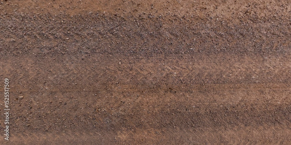 Fototapeta top view of gravel road surface and grass shoulder