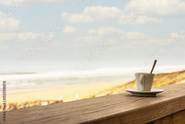 Obraz Cup of coffee or espresso placed on a wooden table facing the sea