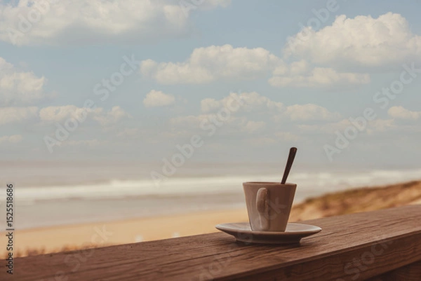 Obraz Cup of coffee or espresso placed on a wooden table facing the sea