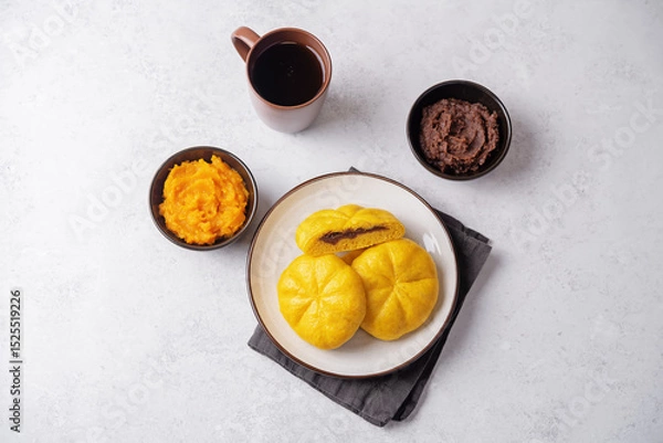 Obraz Pumpkin steamed buns with red bean paste filling in a plate