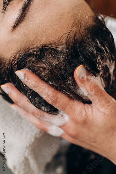 Fototapeta Close‑up spa scalp shampoo foaming on hair during professional scalp treatment