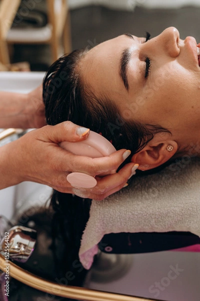 Fototapeta "Spa scalp shampoo session with foaming bubbles and vibrating electric massager for relaxation