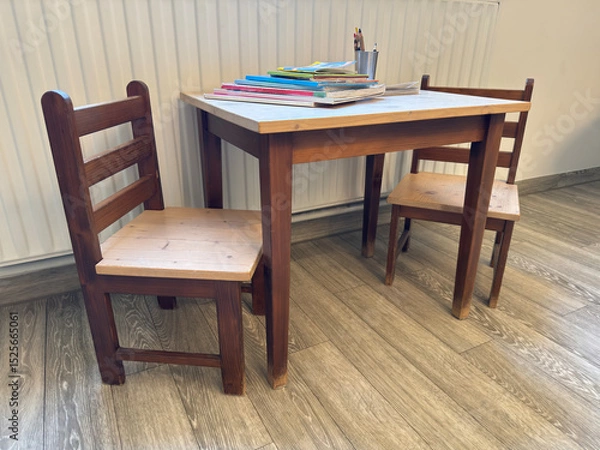 Fototapeta In the waiting room of a German pediatrician, small childrens chairs and a small table are available