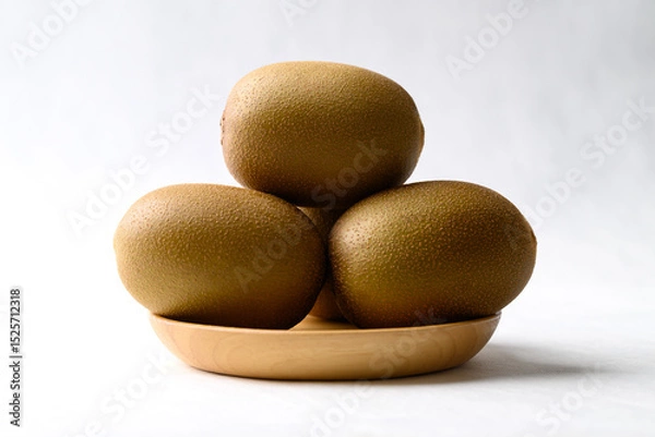 Obraz Fresh kiwi fruit on wooden plate with white background, Healthy fruit
