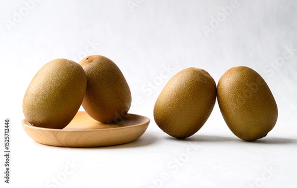 Obraz Fresh kiwi fruit with wooden plate on white background, Healthy fruit