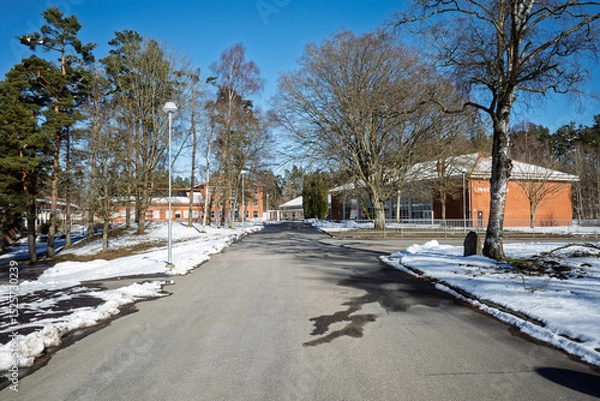 Obraz Linneskolan school road and campus buildings with snow on a sunny winter day in Haessleholm, Sweden