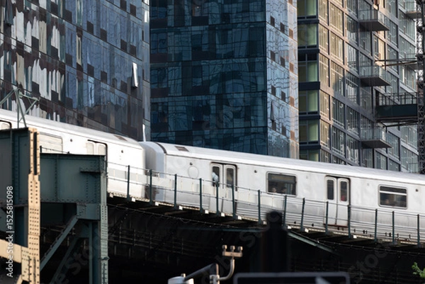 Fototapeta Subway train passing through modern skyscraper apartment buildings