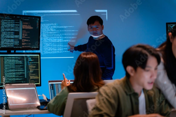 Fototapeta Asian software engineer or programmer team working late in development office,problem solving or algorithm of ai assistant helping for work.software developer,digital technology security concept