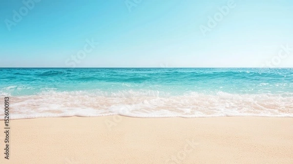 Obraz summer concept. Serene beach with gentle waves under a clear blue sky.