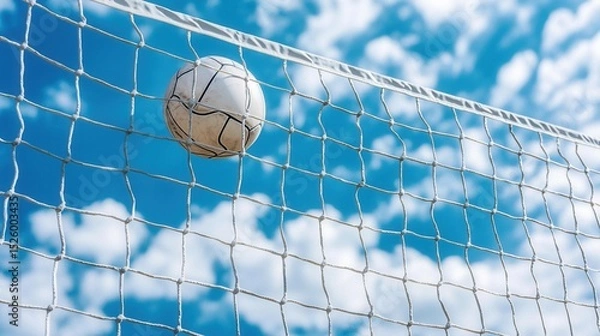 Fototapeta summer concept. Soccer ball hitting the net under a blue sky with clouds.