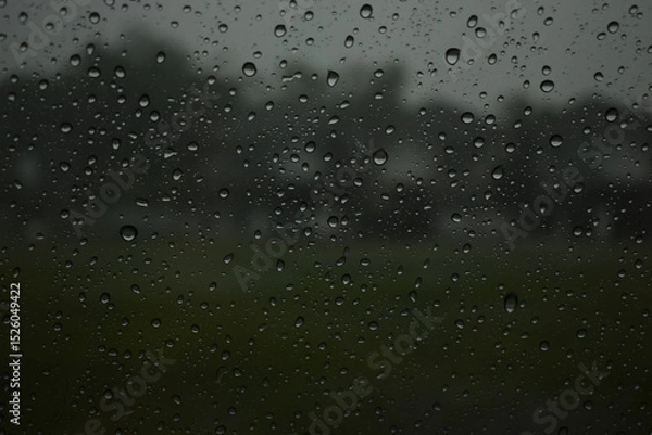Fototapeta water drop on mirror in rainy day, blur natural background