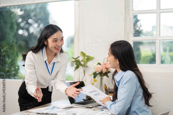 Obraz Engaging Team Discussion. Businesswoman presenting ideas to her colleague in an office setting.