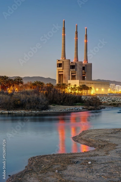 Obraz The shutdown thermal power station and the mouth of the Besos river at Sant Adria near Barcelona at twilight