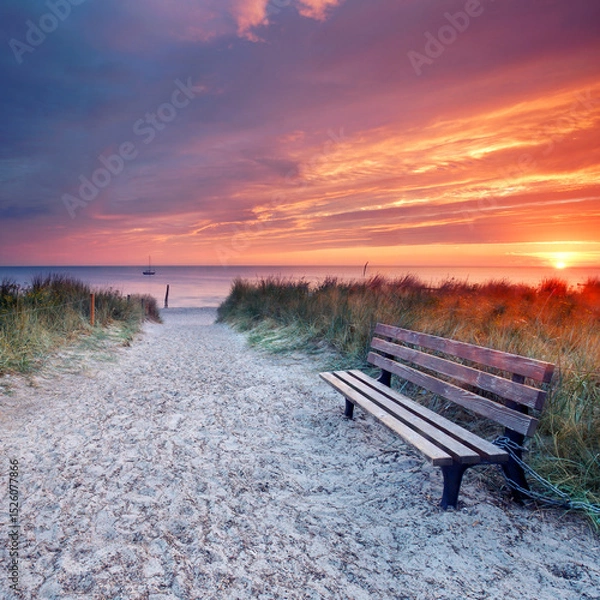 Fototapeta Embracing Freedom: A Lonely Bench Overlooking a Colorful Sunset by the Sea