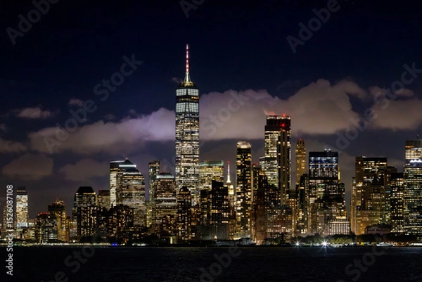 Fototapeta A vibrant sunset panorama of Manhattan downtown skyline, viewed from the river