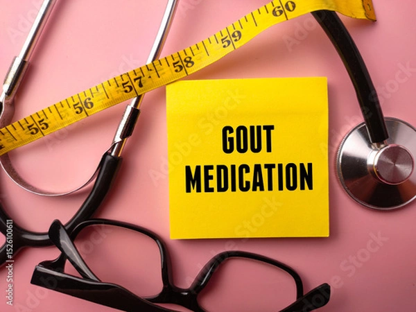 Fototapeta Sticky note and doctor's equipment with the word GOUT MEDICATION on a pink background