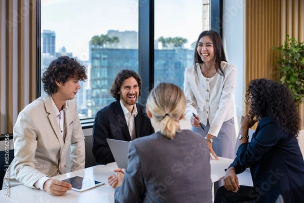 Fototapeta Asian woman sale manager is showing annual report to her colleague in executive meeting for next year plan with market share increase for global business and investment