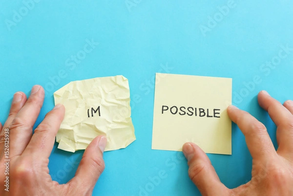Fototapeta The word impossible is divided into two parts. success and challenge concept.