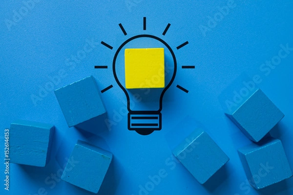 Fototapeta Creative solution,idea generation,innovation, brainstorming,problem-solving,breakthrough and creative thinking concept.,A yellow wooden block forms a glowing filament inside a lightbulb outline.