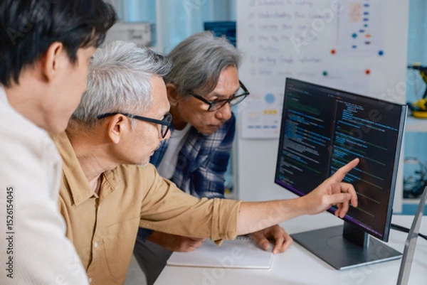 Obraz Team of developers collaborating in brainstorming and coding project at office workspace