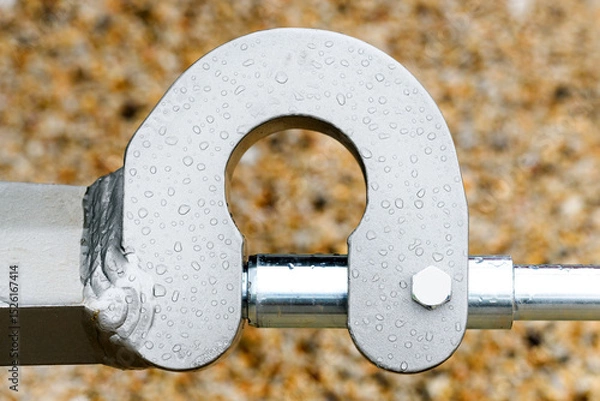 Fototapeta Metallic machine part with hydraulics, raindrops pattern covering metal