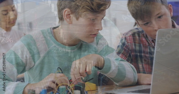 Obraz Image of caucasian students studying in classroom using laptop over globe and graph