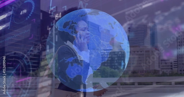 Fototapeta Image of globe and data processing over african american businesswoman talking on smartphone