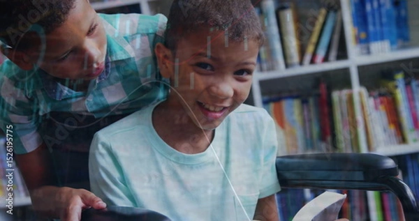 Fototapeta Image of graph moving over boy standing by friend reading book on wheelchair in library