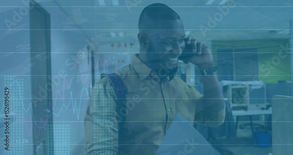 Fototapeta Image of financial data processing over african american businessman using smartphone