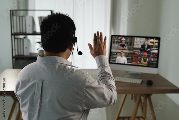 Obraz Virtual Meeting and virtual conference man white shirt participating virtual meeting computer waving to screen with multiple people video call