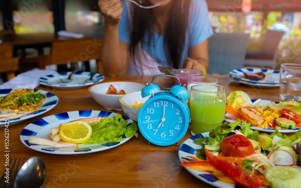 Fototapeta Alarm clock with IF (Intermittent Fasting) 16 and 8 diet rule and weight loss concept.-Diet plan concept